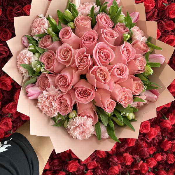 Pink rose bouquet with carnations and tulips wrapped in blush paper