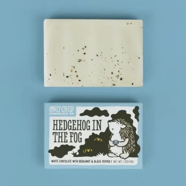 Two chocolate bars on a blue background, one in a labeled box