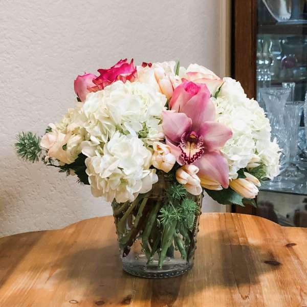 Bouquet of white and pink flowers in a clear glass vase