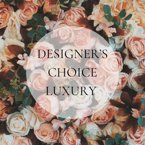 Peach and white roses with greenery and the words "Designer’s Choice Luxury"