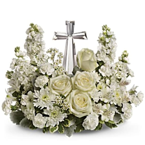White floral sympathy arrangement with a silver cross centerpiece