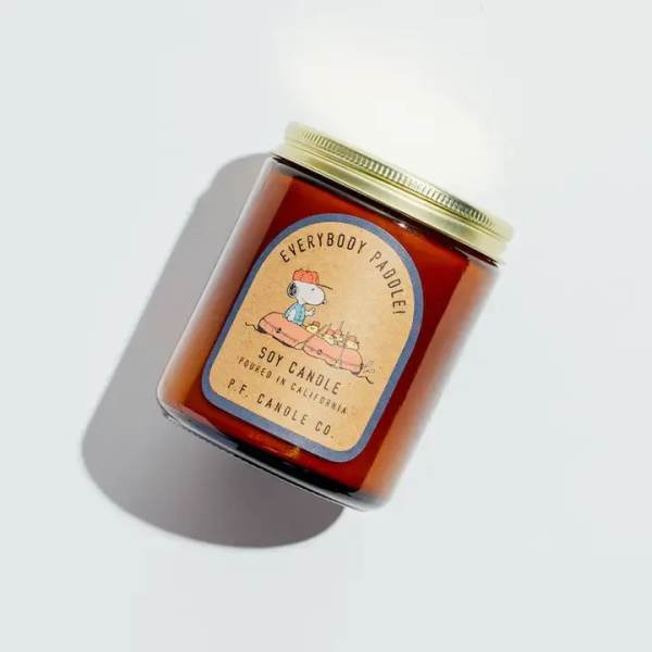 Amber soy candle in a glass jar with a gold lid