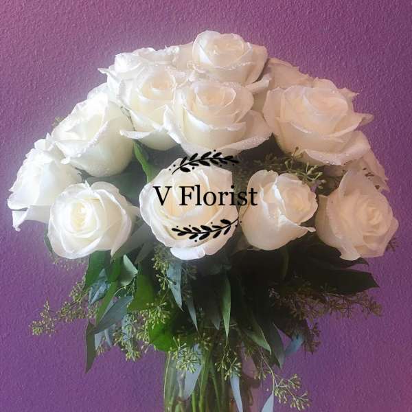 White rose bouquet in a clear glass vase