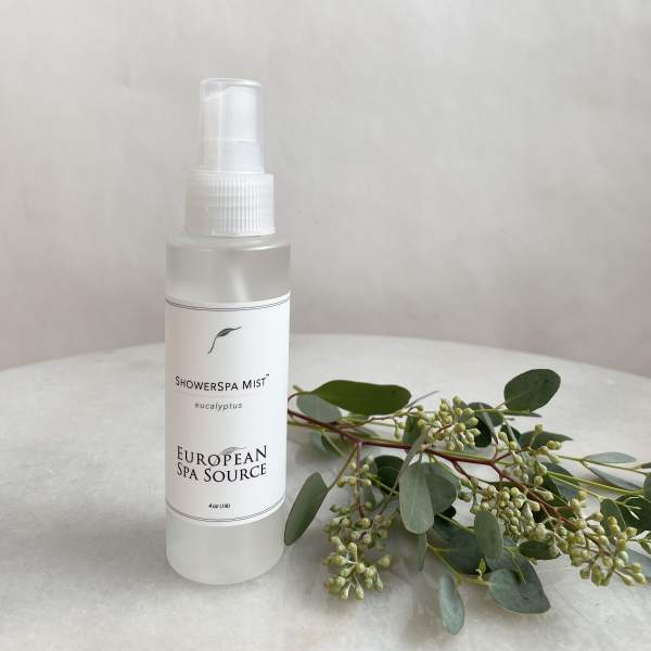 Eucalyptus spray mist bottle beside a eucalyptus stem