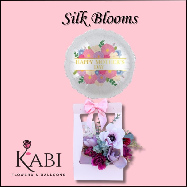 Mother's Day balloon above a pink gift box with silk flowers