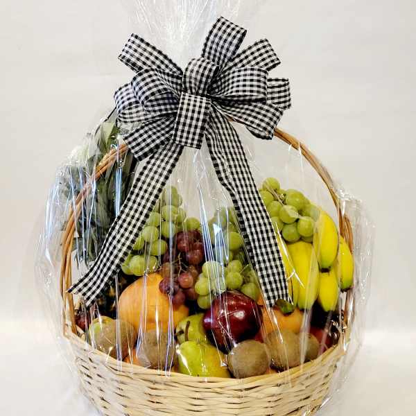 Fruit basket wrapped in cellophane with a black-and-white bow