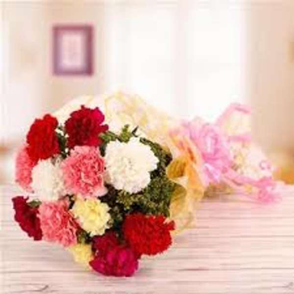 Bouquet of multicolored carnations wrapped in pastel paper
