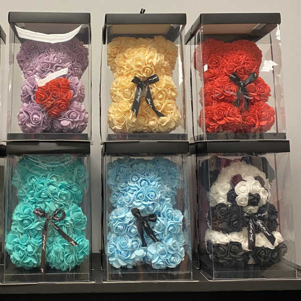 Boxes of rose-shaped artificial flowers in assorted colors