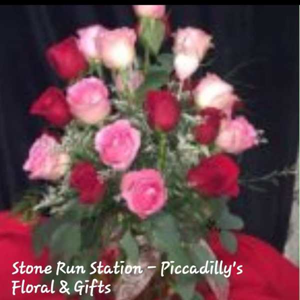 Bouquet of pink and red roses with greenery
