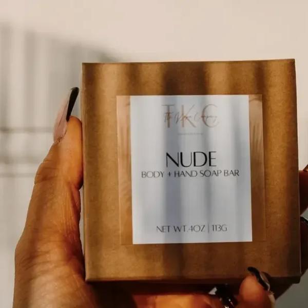 Hand holding a boxed nude body and hand soap bar