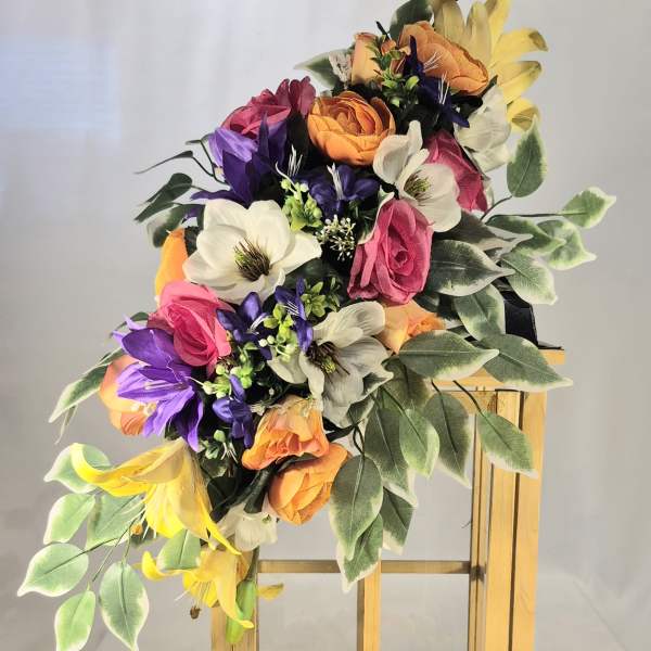 Colorful floral arrangement on a wooden lantern stand