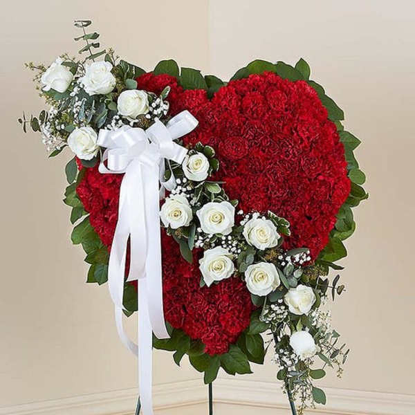 Heart-shaped red floral standing spray with white roses and a white ribbon