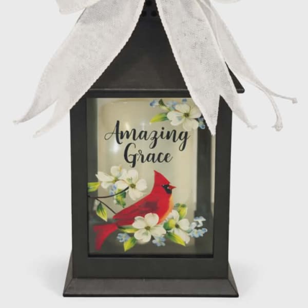Black lantern with a white bow and a cardinal floral design