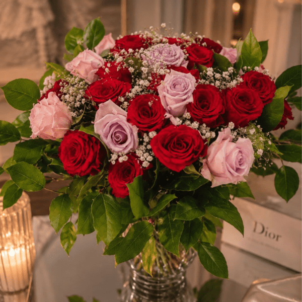 Bouquet of red and pink roses in a clear glass vase