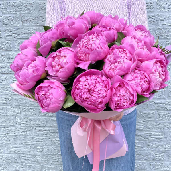 Large bouquet of bright pink peonies wrapped with pink ribbon