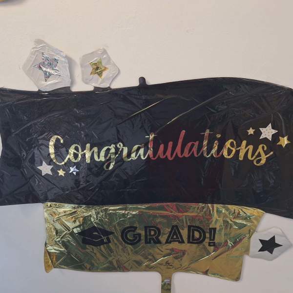 Graduation-themed foil balloons with "Congratulations" and "GRAD!" text