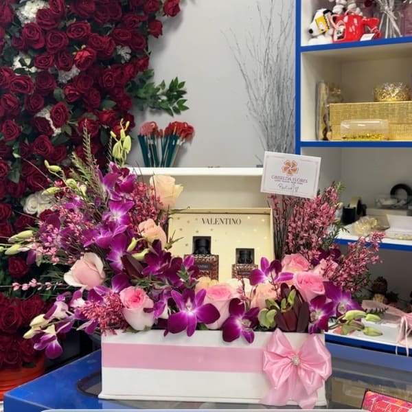 Pink and purple floral gift box with roses and orchids