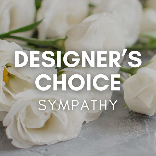 White roses with overlaid text reading Designer's Choice Sympathy
