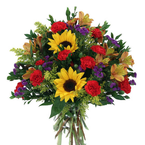 Bouquet of sunflowers, red carnations, and purple accents in a glass vase