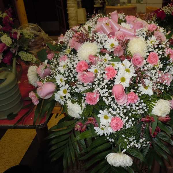 Large pink and white floral spray with ribbon accents