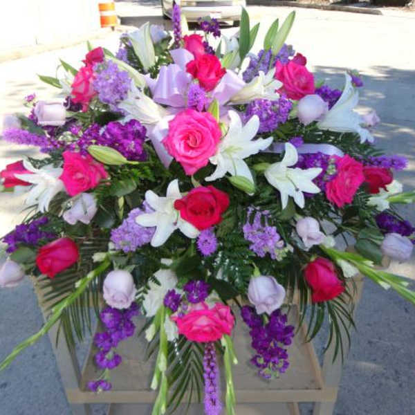 Large bouquet of pink roses and white lilies with purple flowers