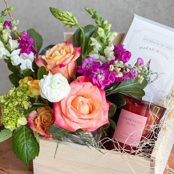 Mixed flower gift box with roses, stock, and a candle