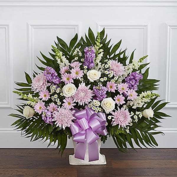 Lavender and white floral standing spray with a purple ribbon