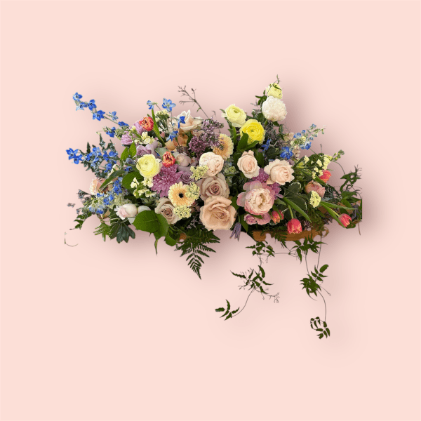 Large mixed bouquet with roses, ranunculus, and blue flowers