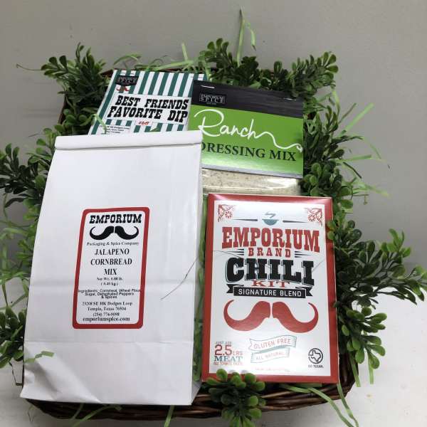 Gift basket with spice mixes and a faux greenery border