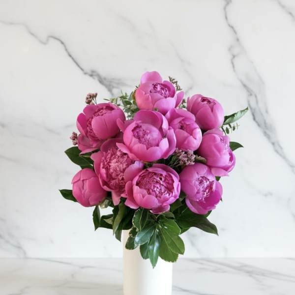 Pink peony bouquet in a white vase