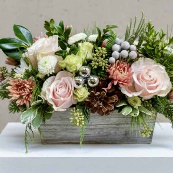 Pink roses and mixed flowers in a rectangular wooden planter