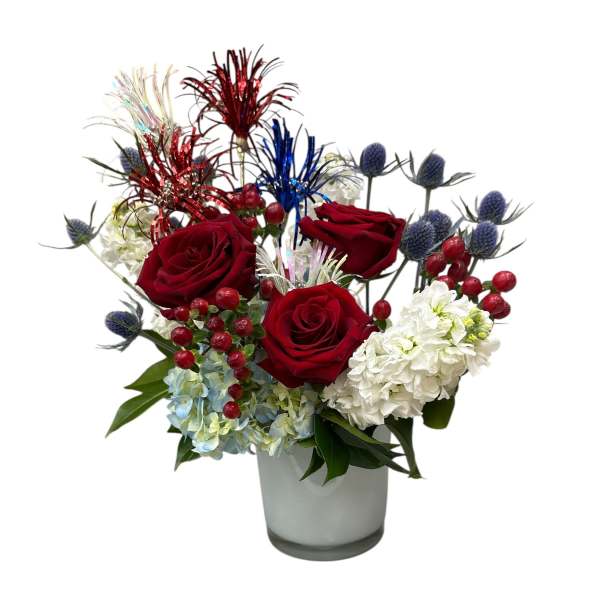 Red roses and white hydrangeas in a glass vase with decorative picks