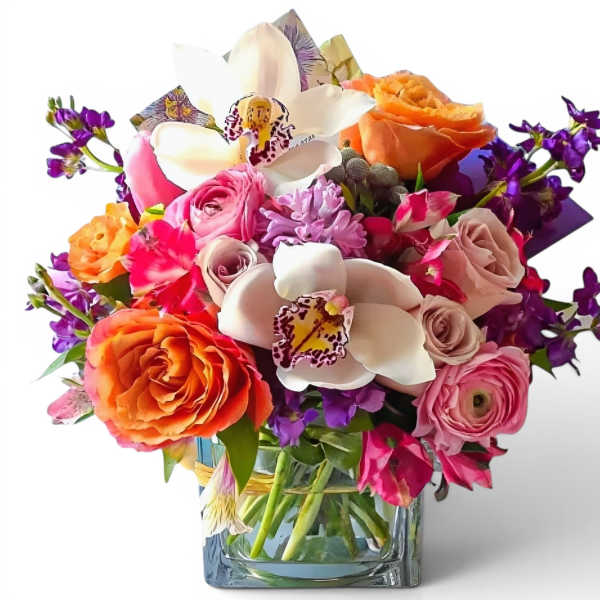 Mixed bouquet with roses, orchids, and purple flowers in a glass vase