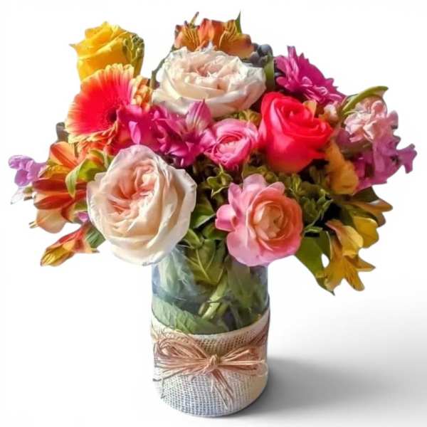Mixed bouquet of roses and gerbera daisies in a wrapped glass vase