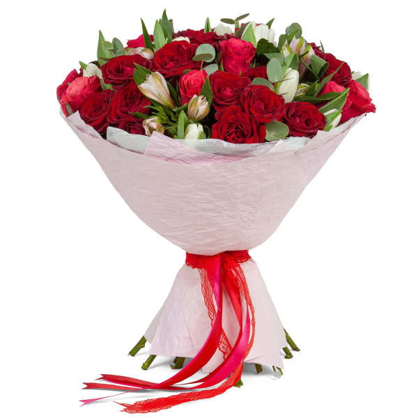 Bouquet of red roses with pink accents wrapped in pale paper