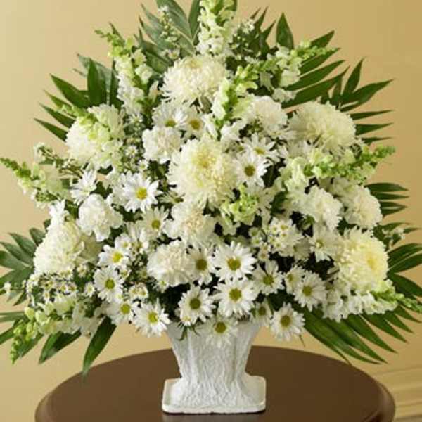 White floral arrangement in a textured white vase