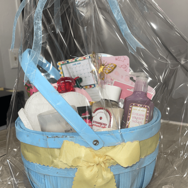 Gift basket with bath and body items wrapped in clear plastic and ribbon
