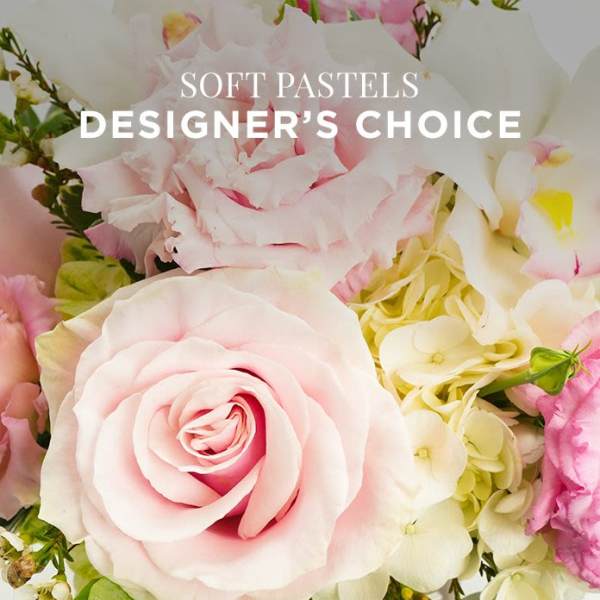 Close-up of a pastel arrangement with pale pink roses and white hydrangeas.