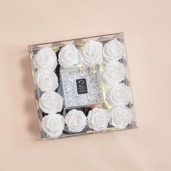 Square box of white roses with a clear jeweled center