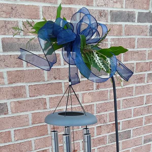Blue ribbon wind chime with a small floral accent