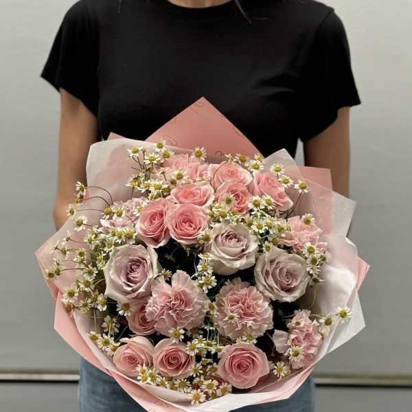 Pink rose bouquet with small white daisies wrapped in pink paper