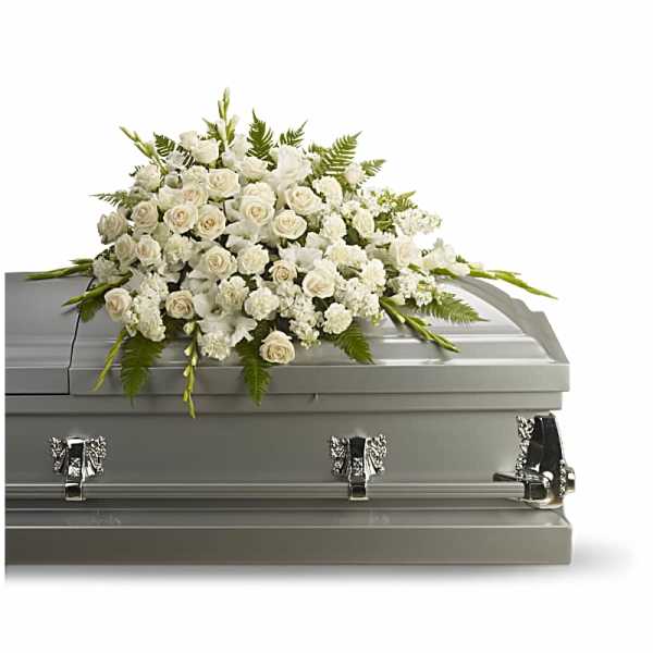 White floral casket spray with roses and lilies