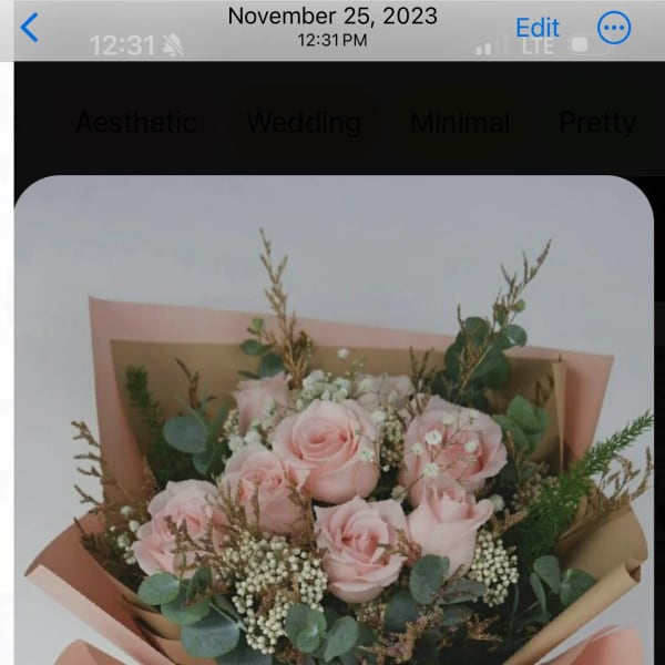 Pink rose bouquet wrapped in blush and kraft paper with a satin ribbon