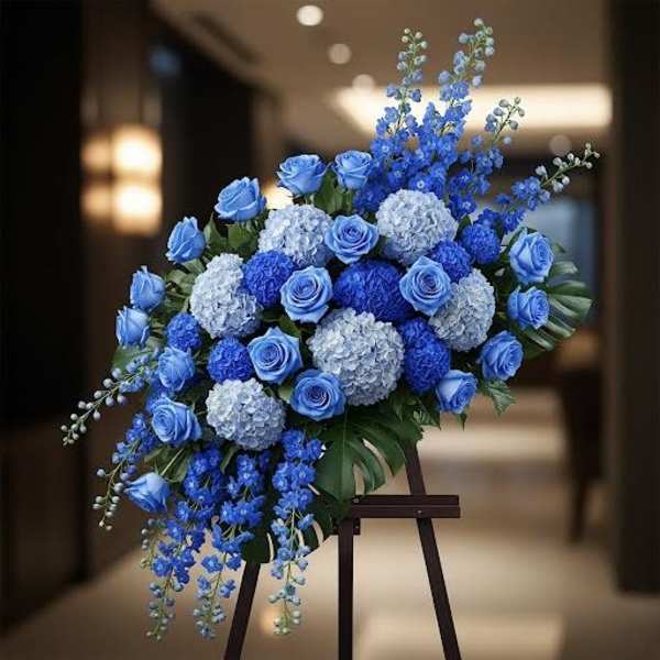Blue and white floral standing spray on an easel