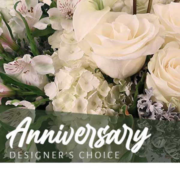 White roses and lilies with hydrangeas in a floral arrangement