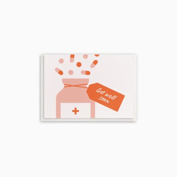 Illustration of a medicine bottle with pills and a get well soon tag