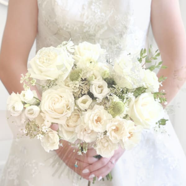 Bride holding a white rose bouquet