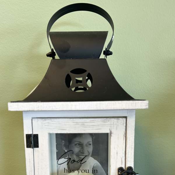 Decorative memorial lantern with a candle and photo inside