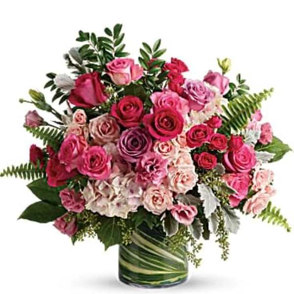 Pink and red rose bouquet in a glass vase