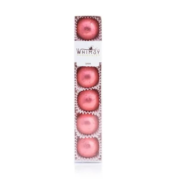 Box of pink chocolate truffles in individual cups